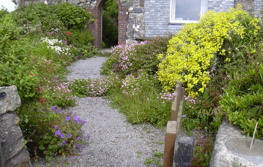 The Loft garden with Sundial and archway to entrance at rear